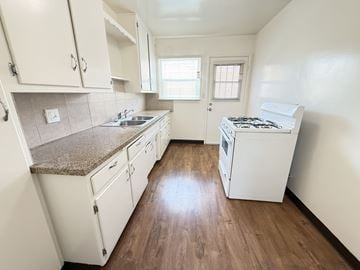 Anaheim apartment for rent - A kitchen with white cabinets and a countertop.