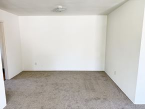 Anaheim apartment for rent - A room with white walls and carpeted floor.
