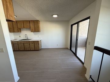 Garden Grove apartment for rent - A kitchen with wooden cabinets and a white countertop.