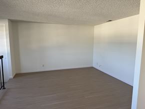 Garden Grove apartment for rent - Empty room with wooden flooring and white walls.