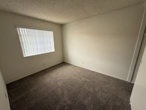 Garden Grove apartment for rent - A room with a carpeted floor and a window with blinds.