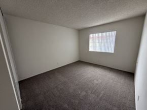 Garden Grove apartment for rent - A room with a carpeted floor and a window with blinds.