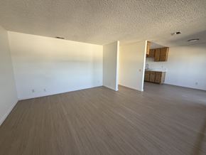 Garden Grove apartment for rent - A room with wooden flooring and white walls.