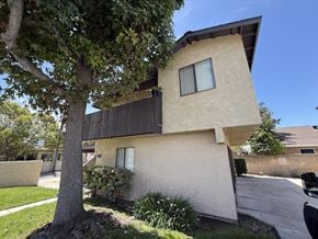 Anaheim apartment for rent - A modern house with a tree in front.