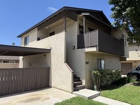 Anaheim apartment for rent - A two-story house with a balcony on the upper floor.