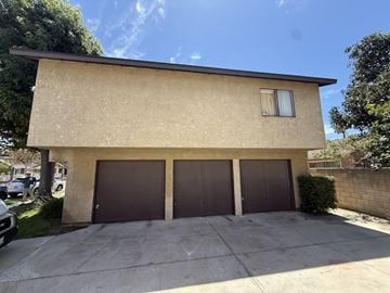 Anaheim apartment for rent - A house with a beige exterior and a brown garage door.