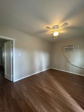 Banning apartment for rent - an empty living room with a ceiling fan and wood floors