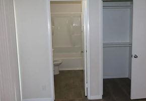 Ontario apartment for rent - a white bathroom with a toilet and a closet