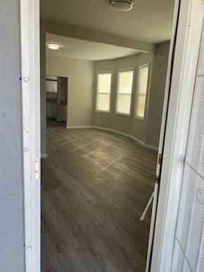 Colton apartment for rent - an empty living room with wood flooring and windows
