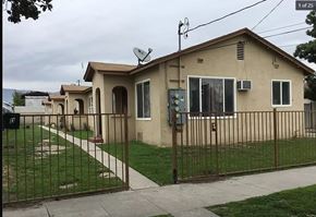 San Bernardino apartment for rent - a row of houses with a fence