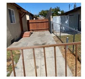 San Bernardino apartment for rent - a yard with a wooden fence and a concrete sidewalk