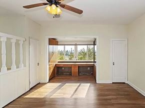 Riverside apartment for rent - a empty room with a ceiling fan and a window