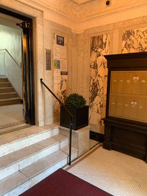 Astoria apartment for rent - A staircase with a red carpet in front of it.