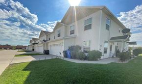 Fargo apartment for rent - a white house with a sidewalk and grass in front of it