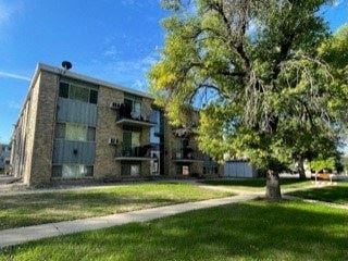 West Fargo apartment for rent - an apartment building with a sidewalk and a tree