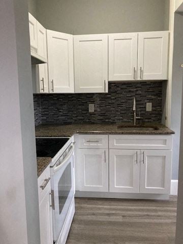 Bristol apartment for rent - a white kitchen with white cabinets and a sink
