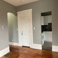 Bristol apartment for rent - an empty room with a door and a kitchen