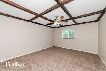 North Port house for rent - a living room with a ceiling fan and carpet