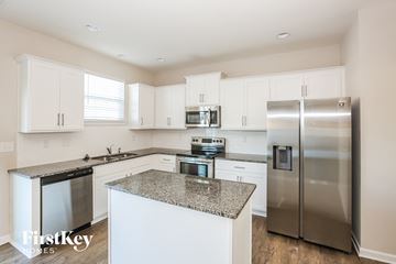 Charlotte house for rent - A kitchen with a granite countertop and stainless steel appliances.