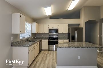 Land O Lakes house for rent - a kitchen with granite counter tops and stainless steel appliances