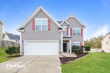Clayton house for rent - a single story home with gray siding and red shutters