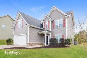 Clayton house for rent - a home with a gray house with red shutters