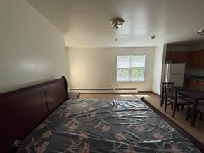 New Haven apartment for rent - A bedroom with a bed, table and chairs.