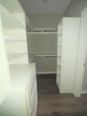 Brownsville house for rent - a closet with white shelves and a wood floor