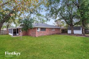 Baytown house for rent - a brick house with a yard and trees