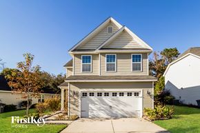 Ladson house for rent - a tan house with a white garage door