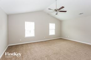 Charlotte house for rent - a bedroom with carpet and a ceiling fan