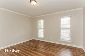 Charlotte house for rent - a living room with a hardwood floor and two windows