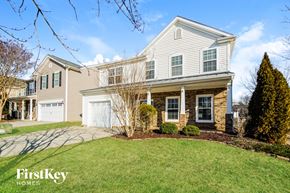 Holly Springs house for rent - a house with a driveway and a lawn in front of it