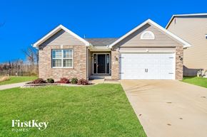 St Peters house for rent - a brick house with a white garage door and a lawn