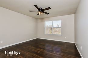 St Peters house for rent - the master bedroom with hardwood flooring and a ceiling fan