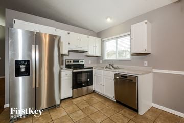 Lake St Louis house for rent - a kitchen with stainless steel appliances and white cabinets