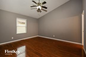 Lake St Louis house for rent - a bedroom with hardwood floors and a ceiling fan