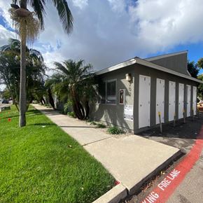 National City apartment for rent - A building with a sign that says "NO PARKING FREE PARKING ONLY" is surrounded by palm trees.