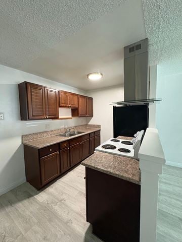 National City apartment for rent - A kitchen with brown cabinets and a granite countertop.