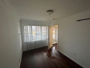 St. Louis apartment for rent - an empty living room with a wood floor and a window