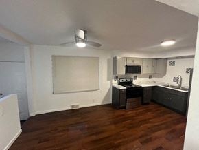 St. Louis apartment for rent - an empty kitchen with a wood floor and black appliances