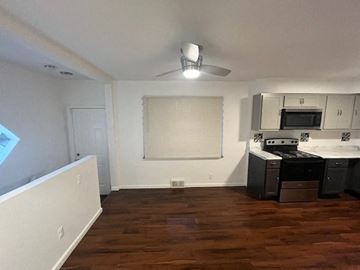 St. Louis apartment for rent - a kitchen with a stove and a ceiling fan