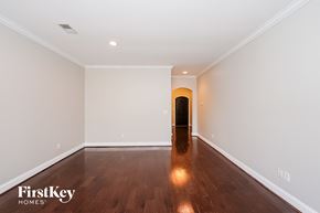 Trussville house for rent - a empty living room with white walls and wooden floors