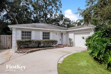 Brandon house for rent - a white house with a driveway and a garage door