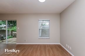 Brandon house for rent - the living room of an empty house with wood floors and a window