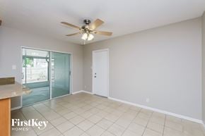 Brandon house for rent - a living room with a ceiling fan and a sliding glass door