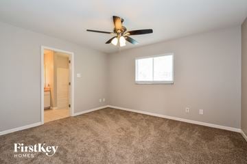 Cape Coral house for rent - a living room with carpet and a ceiling fan
