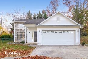 Winston Salem house for rent - a white house with a driveway and a white garage door