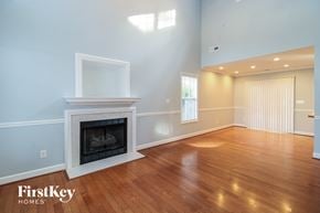 Winston Salem house for rent - a living room with a fireplace and a wooden floor
