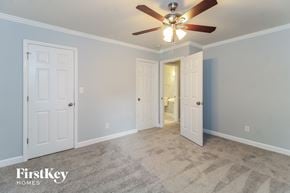 Winston Salem house for rent - a bedroom with two closets and a ceiling fan